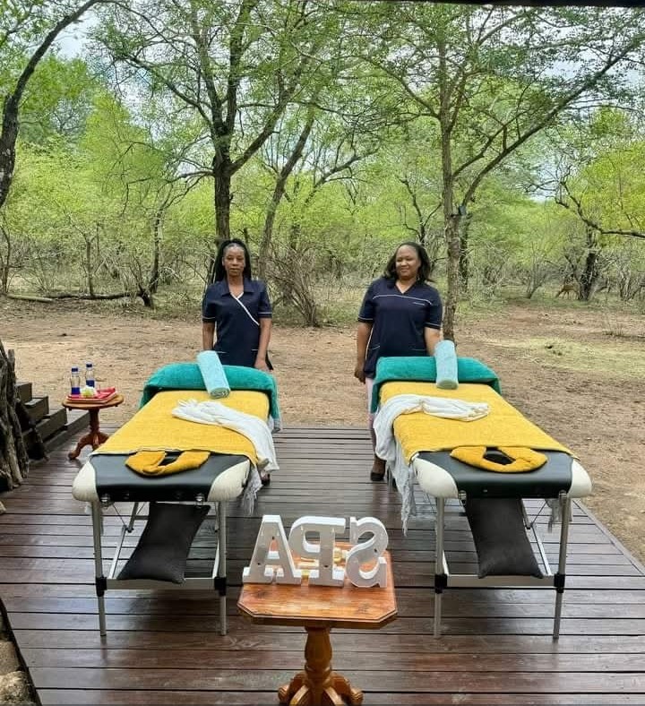 Two spa beds set up outdoors among the trees